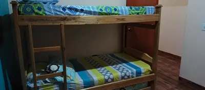 a bunk bed with a clock on the bottom bunk at Finca campestre y recreativa los potrillos in Doradal