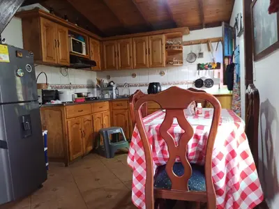 a kitchen with a table with a red and white checkered table cloth at Finca Alejandria (Condominio la Chiquita) in Marinilla