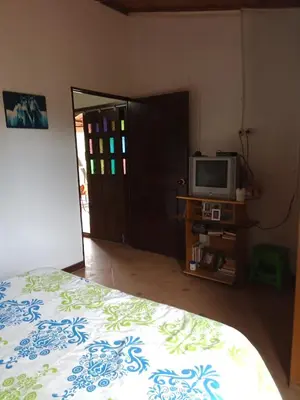 a bedroom with a bed and a tv on a table at Finca Alejandria (Condominio la Chiquita) in Marinilla