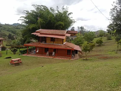 a small house with a picnic table in front of it at Finca Alejandria (Condominio la Chiquita) in Marinilla