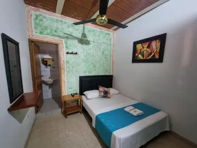 a small bedroom with a bed and a bathroom at Hotel imperial in Doradal