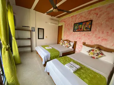 a hotel room with two beds and a couch at Hotel imperial in Doradal