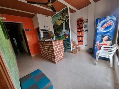 a room with a fireplace and a wall with paintings at Hotel imperial in Doradal