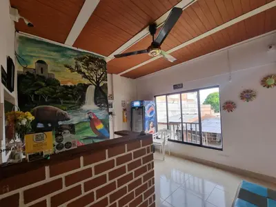 a living room with a painting on the wall at Hotel imperial in Doradal