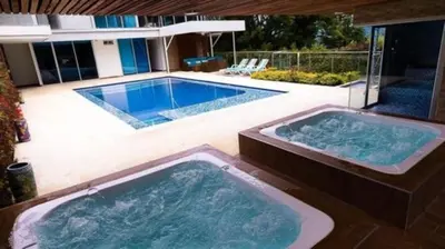 two large jacuzzi tubs in a swimming pool at Libertg Hotels Medellin in Copacabana