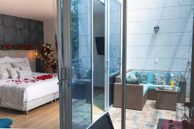 a bedroom with a bed and a glass door at Libertg Hotels Medellin in Copacabana