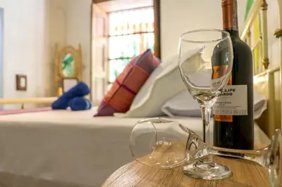 a bottle of wine and a wine glass on a table at Finca La Manchuria in Salgar