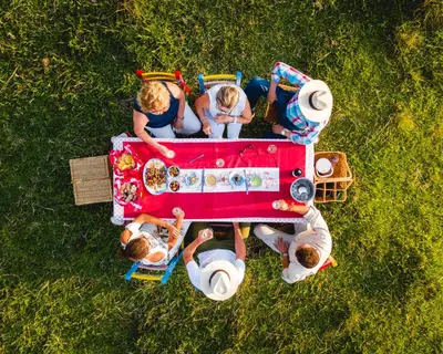 a group of people sitting around a picnic table at Finca La Manchuria in Salgar