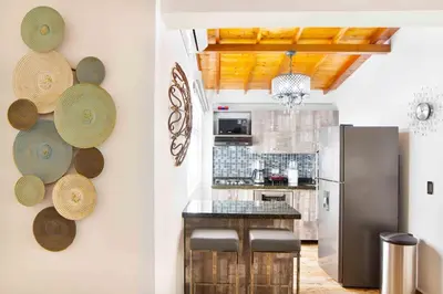 a kitchen with a refrigerator and straw hats on the wall at Miracle in Medellín