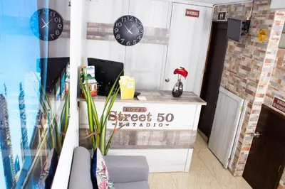 a office with clocks on the wall and a desk at Hotel Boutique Street 50 in Medellín