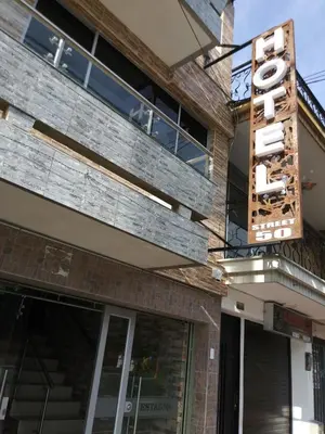 a sign on the side of a building at Hotel Boutique Street 50 in Medellín