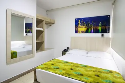 a bedroom with a bed and a mirror at Hotel Boutique Street 50 in Medellín