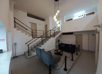 a staircase in a building with blue chairs at Hotel Colombia Avenida in Medellín
