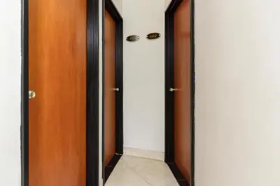 a hallway with two wooden doors and a tile floor at Hotel Colombia Avenida in Medellín