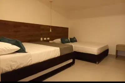 two beds in a hotel room with two beds at Hotel Colombia Avenida in Medellín