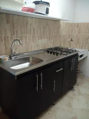 a kitchen with a sink and a stove at Apartamento de Guatapé in Guatapé