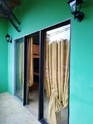 a room with green walls and a window with curtains at Apartamento de Guatapé in Guatapé