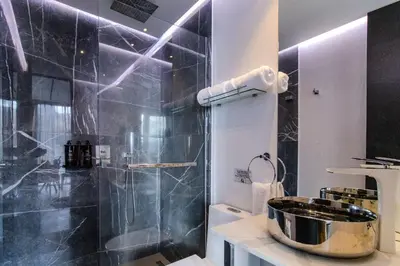 a bathroom with a shower and a sink at Haven, A Design Hotel in Medellín