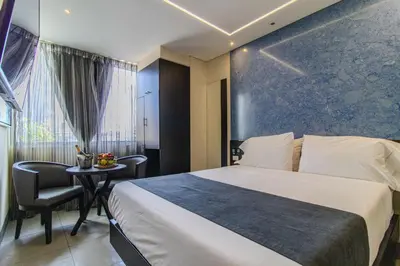 a hotel room with a bed and a table at Haven, A Design Hotel in Medellín