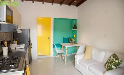 a living room with a white couch and a table at Apartamento remodelado en el mejor sitio del centro de Medellín Home Aris 401 in Medellín
