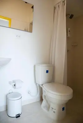 a bathroom with a white toilet and a shower at Apartamento remodelado en el mejor sitio del centro de Medellín Home Aris 401 in Medellín