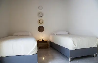 two beds sitting next to each other in a room at Apartamento remodelado en el mejor sitio del centro de Medellín Home Aris 401 in Medellín
