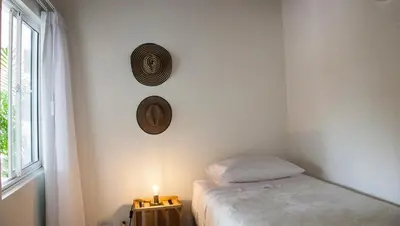 a bedroom with a bed and a hat on the wall at Apartamento remodelado en el mejor lugar del centro de Medellín. Home Aris 402 in Medellín