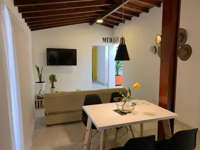 a living room with a table and a couch at Apartamento remodelado en el mejor lugar del centro de Medellín. Home Aris 402 in Medellín