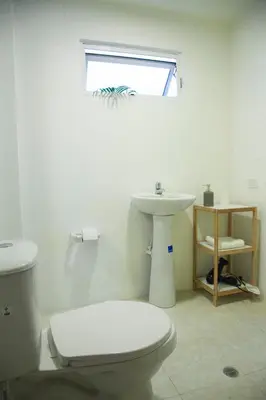 a bathroom with a white toilet and a sink at Apartamento remodelado en el mejor lugar del centro de Medellín. Home Aris 402 in Medellín
