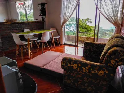 a living room with a couch and a table and chairs at Casa Descanso en el Campo con Hermosa Vista a los Farallones in Versalles