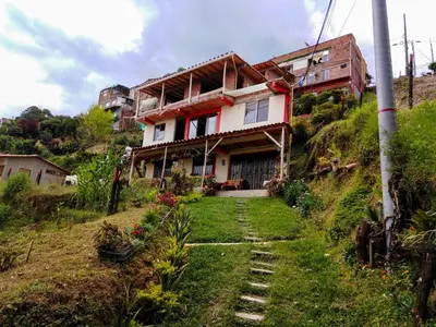 a house on the side of a hill at Casa Descanso en el Campo con Hermosa Vista a los Farallones in Versalles
