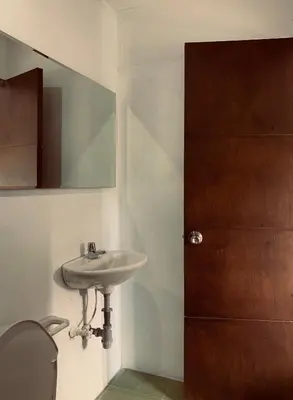 a bathroom with a sink and a mirror and a toilet at Hotel Los Mangos in San Luis