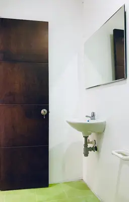a bathroom with a sink and a mirror at Hotel Los Mangos in San Luis