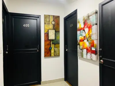 two doors in a room with paintings on the wall at Hotel Lleras Premium #1 in Medellín