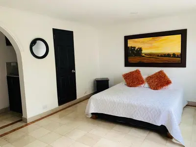 a bedroom with a bed and a painting on the wall at Hotel Lleras Premium #1 in Medellín
