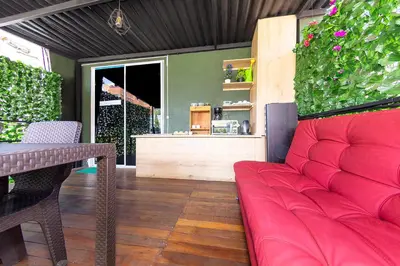 a living room with a red couch and a table at Hotel Ayenda Palo Alto in Medellín