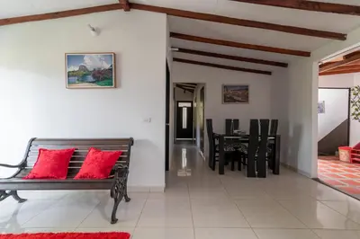 a living room with a bench and a table at CAMPO VALDES PARK HOSTEL in Medellín