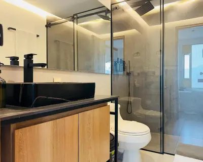 a bathroom with a sink and a toilet and a shower at Hotel Casa Victoria in Medellín