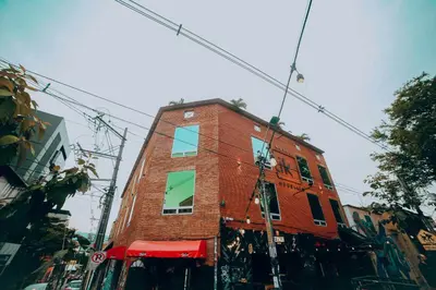 a red brick building on the side of a street at Tik by Bernalo Hotels in Medellín
