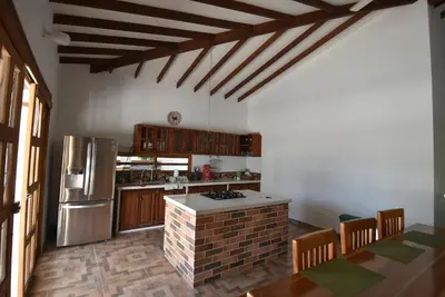 a kitchen with a stove and a refrigerator at Villa Ilusion 88 in Puerto Boyacá