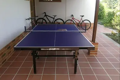 a ping pong table in a room with bikes at Villa Ilusion 88 in Puerto Boyacá