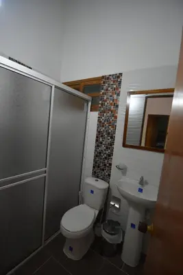 a bathroom with a toilet and a sink at Villa Ilusion 88 in Puerto Boyacá