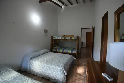 a bedroom with two beds and a wooden floor at Villa Ilusion 88 in Puerto Boyacá
