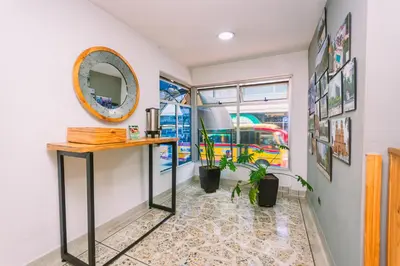 a room with a table and a mirror on the wall at Mandala Medellín Centro By GyC Hotels in Medellín