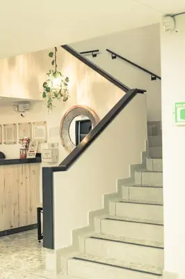 a staircase in a home with a round mirror at Mandala Medellín Centro By GyC Hotels in Medellín