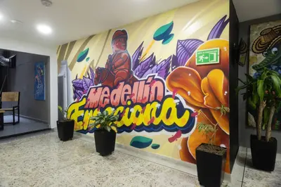 a room with a large painting on the wall at Mandala Medellín Centro By GyC Hotels in Medellín
