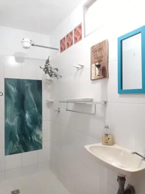 a white bathroom with a sink and a mirror at Alojamiento Rural Jardín Consentido in Jardin