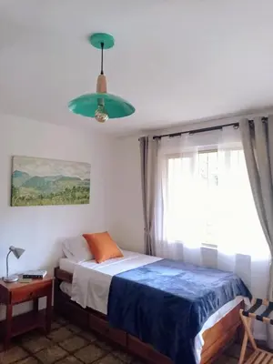 a bedroom with a bed and a large window at Alojamiento Rural Jardín Consentido in Jardin
