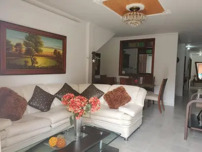 a living room with a white couch and a vase of flowers at Rosita 3 in Jardin