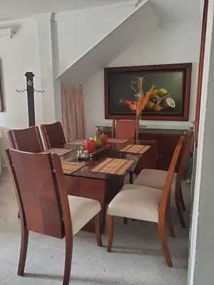 a dining room with a table and chairs and a painting at Rosita 3 in Jardin